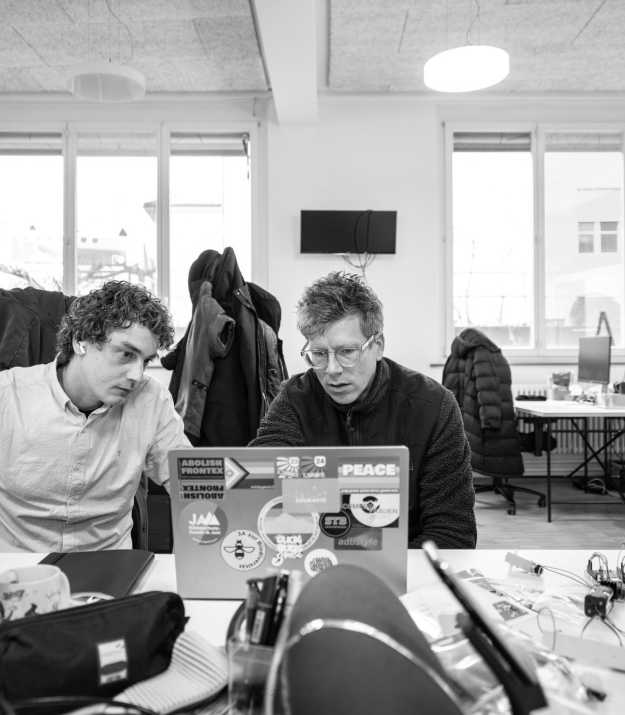Corsin and Adrian look at a laptop together
