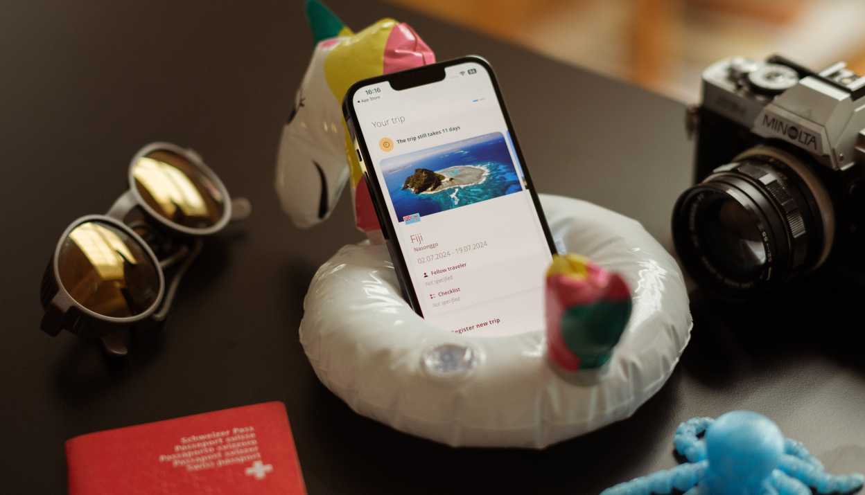 The EDA's Travel Admin app opened on an iPhone placed in a small inflatable swimming ring