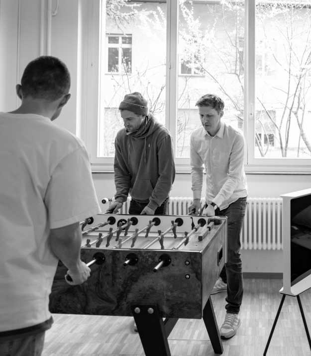 Roman and Till playing table football